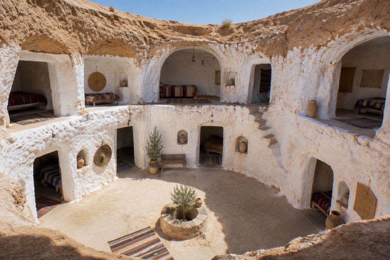 Whitewashed cave hotel courtyard open to the desert sky, Matmata, Tunisia