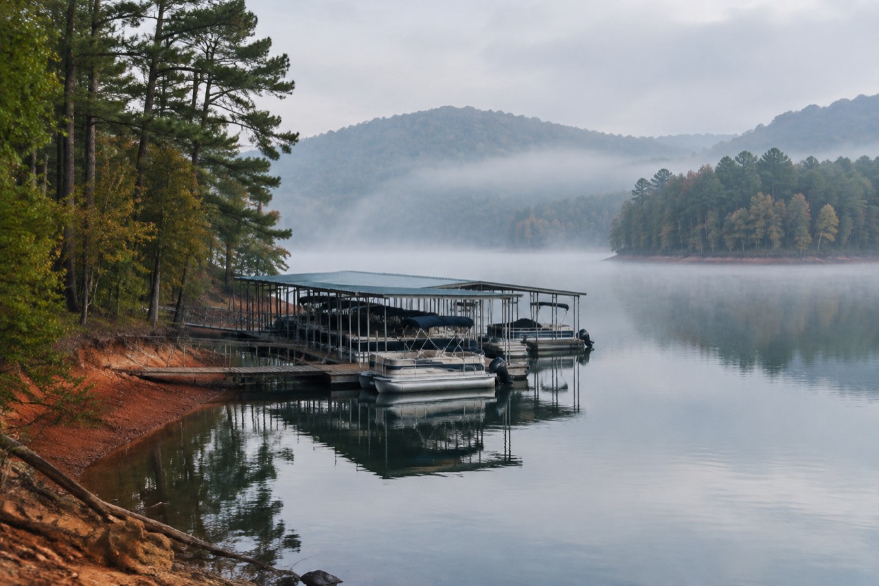 Wooden dock and marina slips on a misty southern lake at dawn