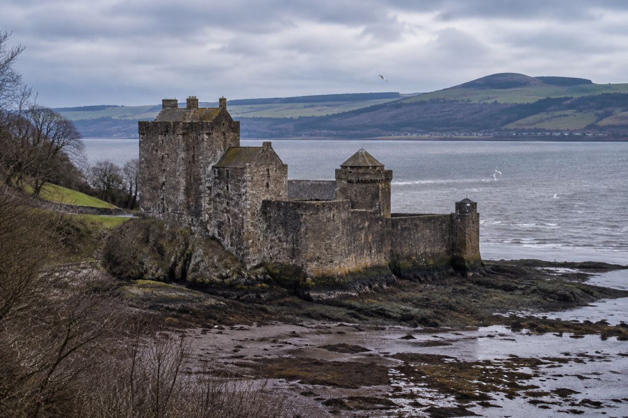 Blackness Castle's grey stone fortress on the Firth of Forth shore under overcast skies