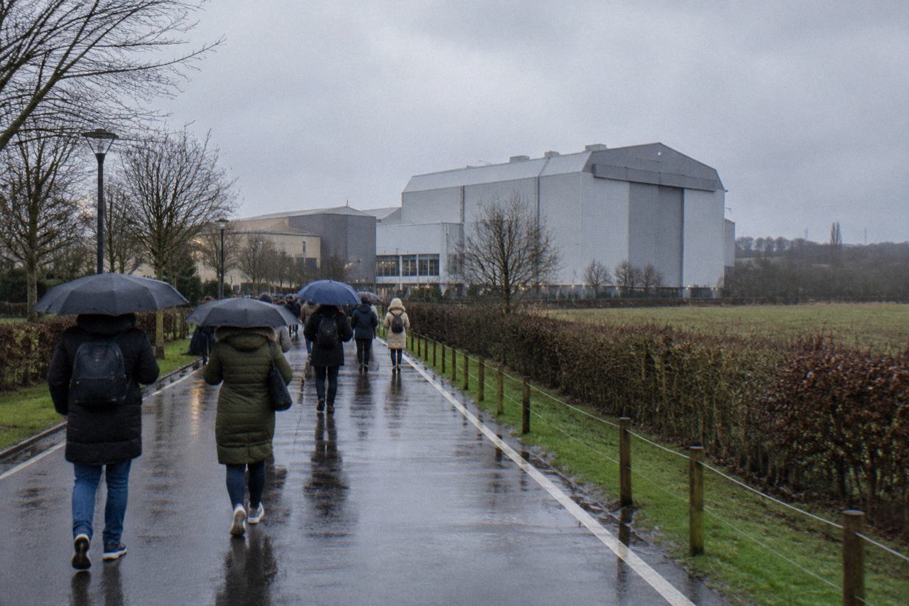 Grey hangar buildings of a film studio in the English countryside on a wet day